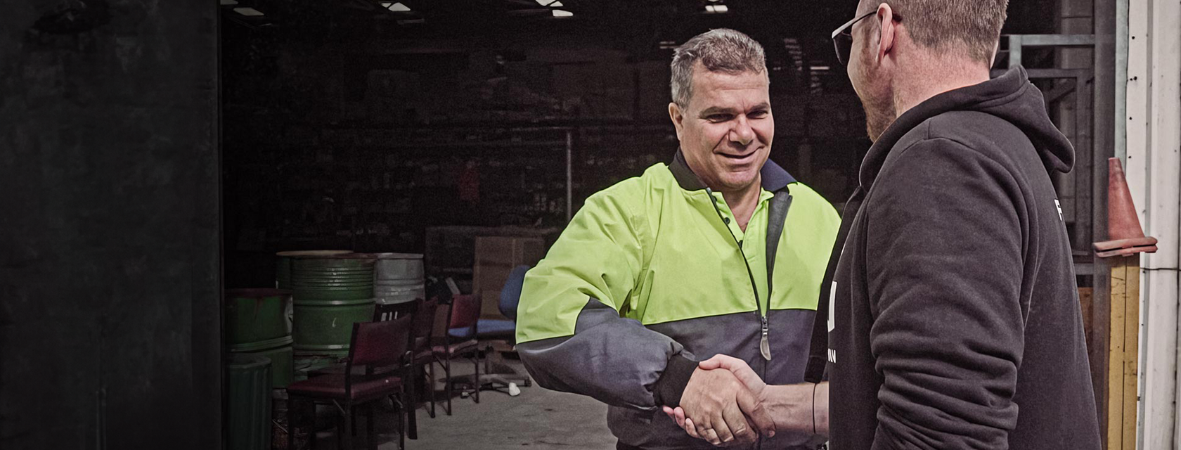 An AEG Onsite rep shakes hands with a tradie
